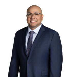 man in suit and tie, possibly a divorce and child custody lawyer, smiles at the camera showing the confidence of an experienced attorney