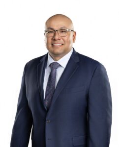 man in suit and tie with glasses looks confidently at the camera, showing the confidence of an experienced divorce and child custody lawyer