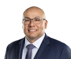 man in suit and tie, possibly a divorce and child custody lawyer, smiles at the camera showing the confidence of an experienced attorney