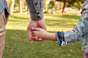 parent and child holding hands when searching for 'child custody lawyer'