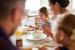 parents spending time with their children by helping them prepare a meal