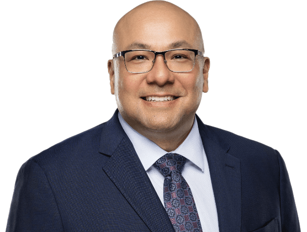 man in suit and tie, possibly a divorce and child custody lawyer, smiles at the camera showing the confidence of an experienced attorney